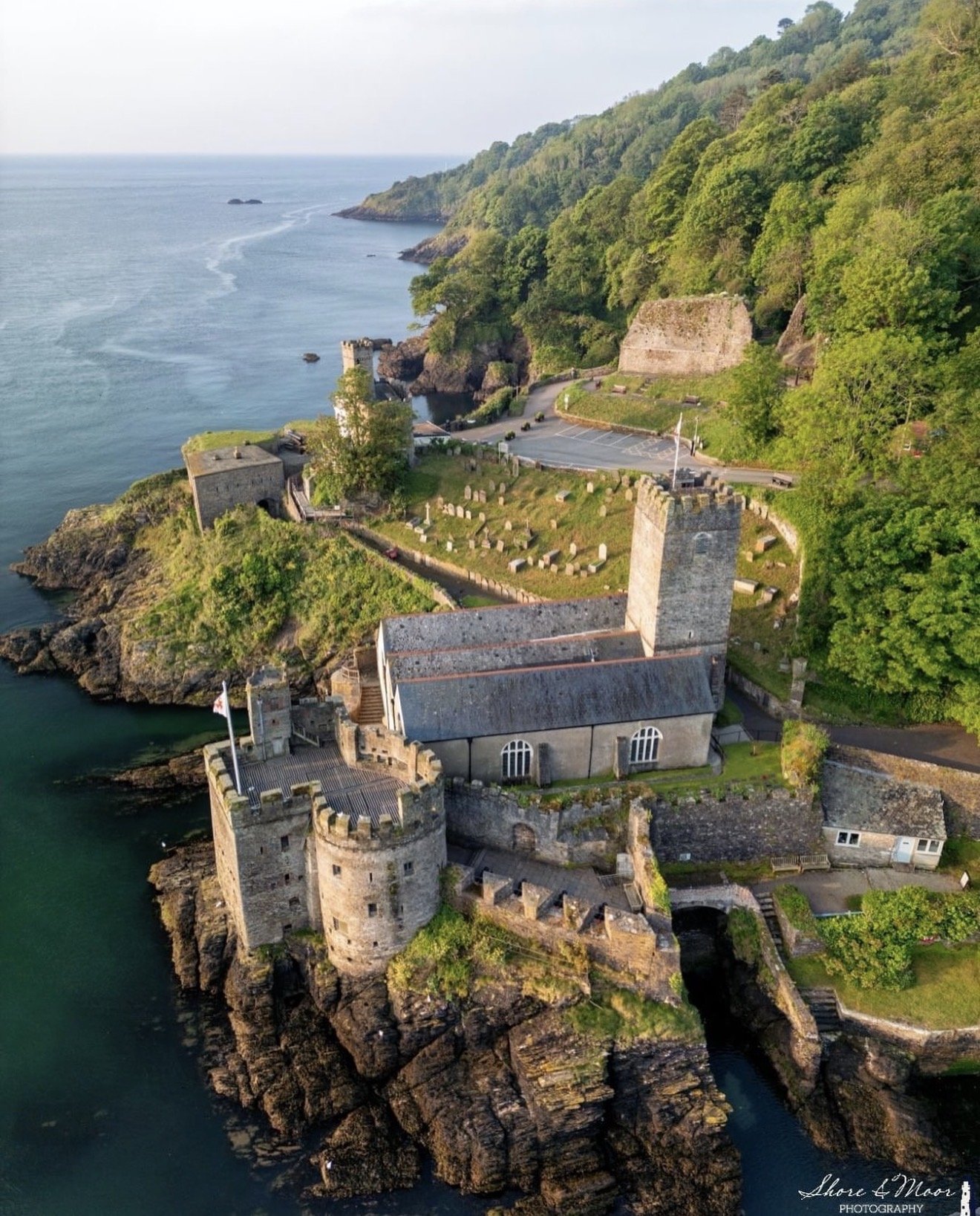 St Petrox Church at Dartmouth Castle with the River Dart and green hillside behind